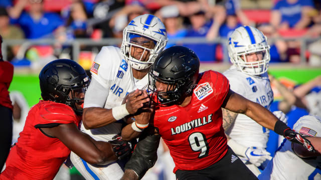 Air Force Falcons quarterback Haaziq Daniels (4) reacts to being hit by Louisville Cardinals linebacker C.J. Avery (9) during the First Responder Bowl at Gerald J. Ford Stadium in Dallas in 2021.